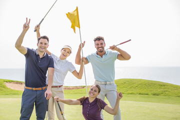 Enthusiastic friends waving on golf course
