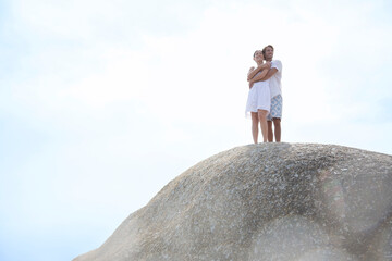 Couple hugging on rock formation