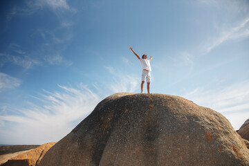 Man standing on top of rock formation