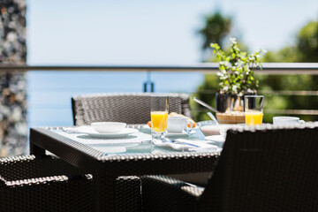 Breakfast on luxury patio dining table overlooking ocean