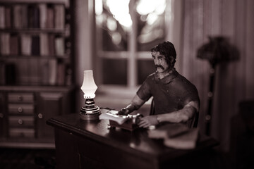 A realistic dollhouse living room with furniture and window at night. Artwork table decoration with handmade realistic dollhouse.