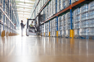 Workers with forklift in bottling warehouse - obrazy, fototapety, plakaty
