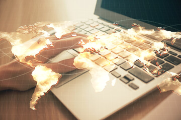 Double exposure of woman hands typing on computer and business theme hologram drawing. Success concept.