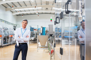 Businessman smiling in factory
