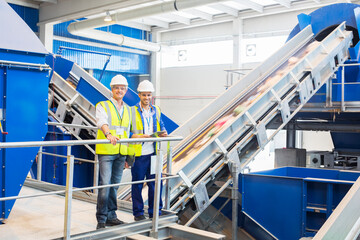 Workers smiling in recycling center