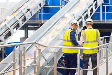 Workers talking in recycling center