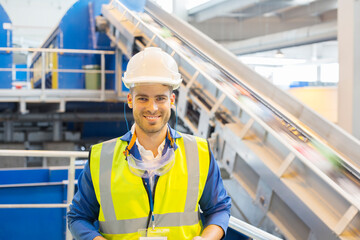 Worker smiling in recycling center