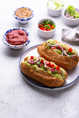 Hot dogs with sausage, sauces and vegetables
