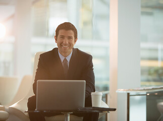 Businessman using laptop in office