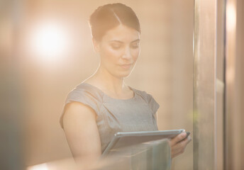 Businesswoman using digital tablet in office