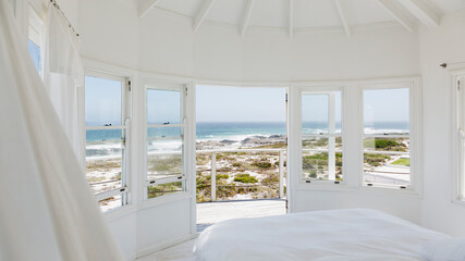 Fototapeta na wymiar White bedroom overlooking ocean