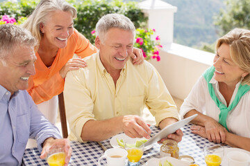 Older couples using digital tablet