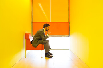 Businessman thinking in bright office