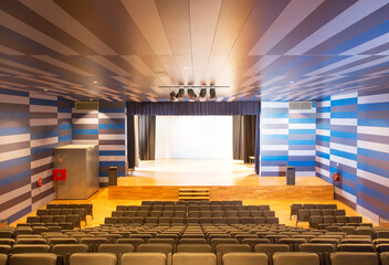 Seating and stage in empty auditorium - obrazy, fototapety, plakaty
