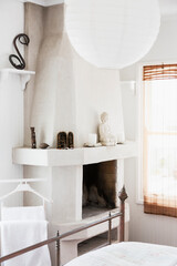 Buddha on fireplace in bedroom