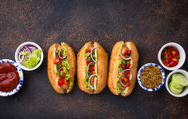 Hot dogs with sausage, sauces and vegetables