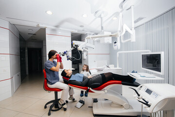 A little girl supports her mother during treatment at the dentist