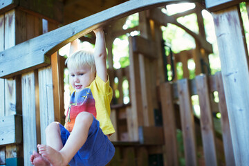 Boy playing on playset outdoors