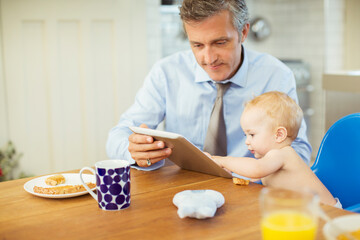 Obraz na płótnie Canvas Father and baby using digital tablet