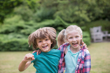 Fototapeta premium Smiling children hugging outdoors