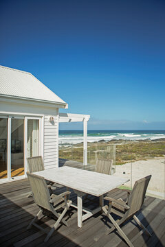 Table And Chairs On Patio Overlooking Beach