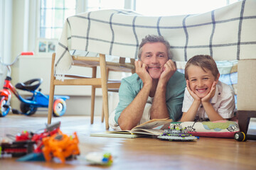 Father and son reading together