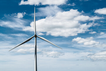 Wind turbineagainst blue sky with clouds on Whitelee wind farm, Scotland, on a  sunny day.