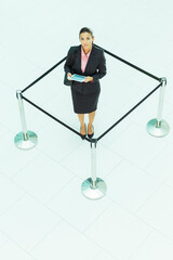 Businesswoman standing in roped-off square