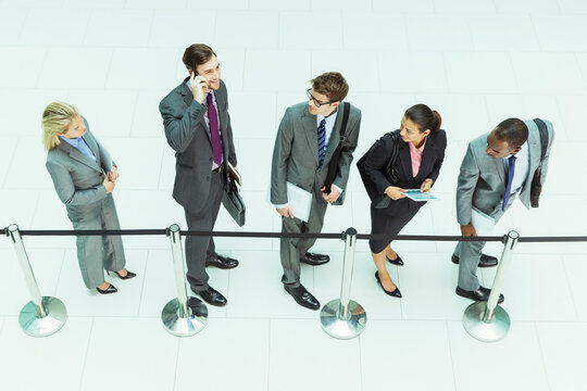 Businessman talking on cell phone in waiting area
