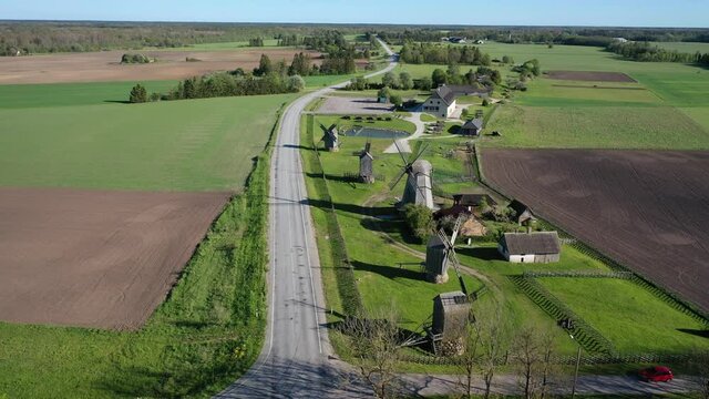 Beautiful panoramic aerial 4K video from flying drone to summer fields and Angla windmills in Leisi Parish. Saarema Island, Estonia. (series)