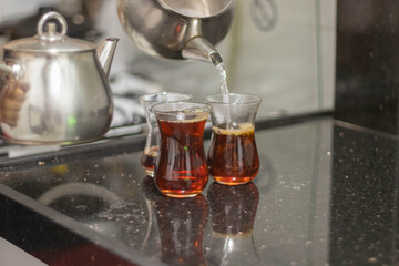 Turkish tea with authentic glass cup and silver tea kettle. 