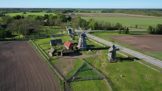 Beautiful panoramic aerial 4K video from flying drone to summer fields and Angla windmills in Leisi Parish. Saarema Island, Estonia. (series)