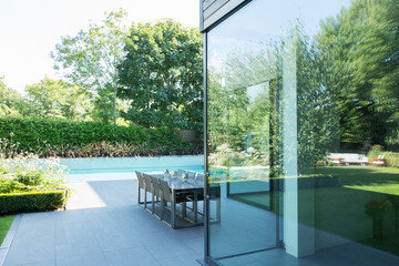 Table and chairs on patio by swimming pool