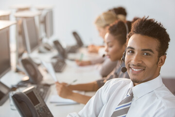 Businessman wearing headset in office