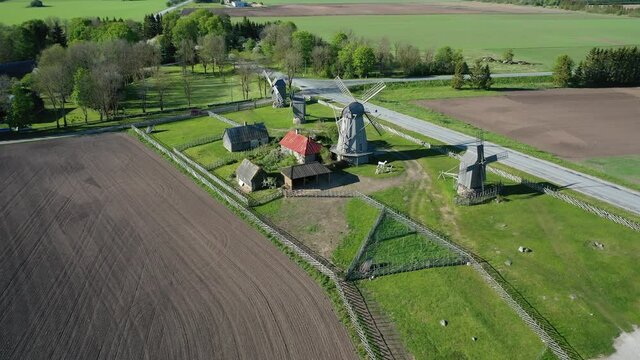 Beautiful panoramic aerial 4K video from flying drone to summer fields and Angla windmills in Leisi Parish. Saarema Island, Estonia. (series)