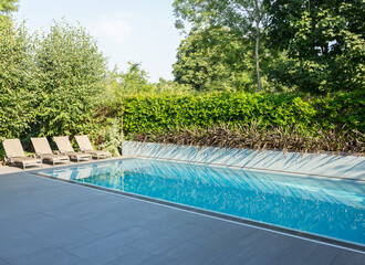 Lounge chairs by luxury lap pool