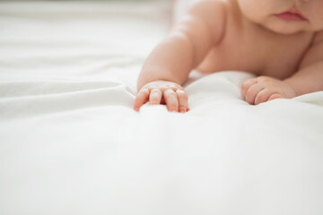 Baby girl laying on bed