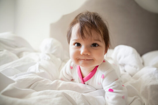 Baby Girl Crawling In Bed Sheets