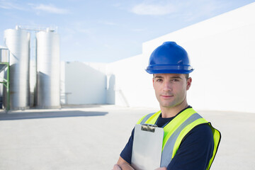 Portrait of confident worker with clipboard at granary