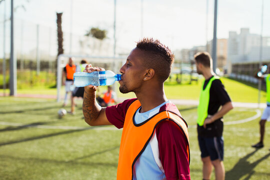 Soccer player drinking water on field