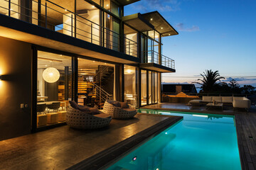 Luxury house with swimming pool illuminated at night