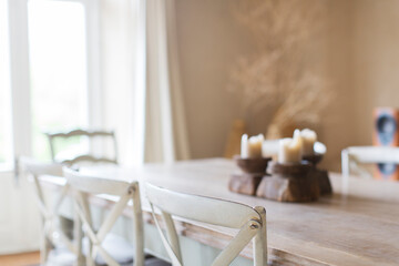 Candles on dining table of rustic house