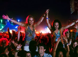  Cheering women on mens shoulders at music festival © Paul Bradbury/KOTO