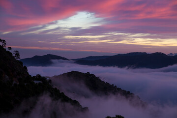 Dramatic sky and fog among mountains
