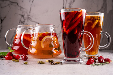 Mulled wine in a glass, tall, transparent glass with cinnamon and lemon