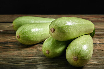 White zucchini on a wooden background, layout for a healthy diet and organic advertising of restaurant cooking
