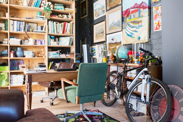 Desk, bookshelves and bicycle in study