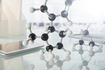 Molecular model and digital tablet on counter in lab