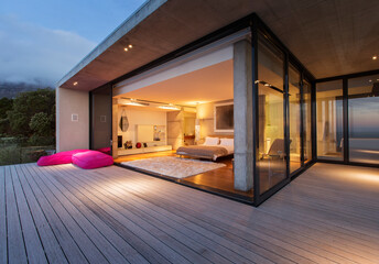 Fototapeta Sliding glass doors onto bedroom of modern house obraz