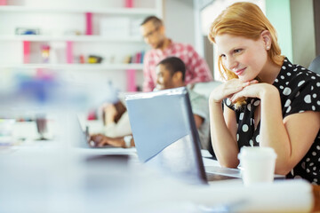 People working at conference table in office